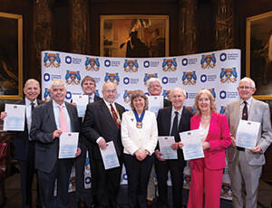 The 50 Members: John Wosner, Alastair Godfrey, Michael Saunders, Ian Luder, Charlotte Barbour (CIOT President), John Dixon, John Clark, Patricia Pearl and Anthony Brown.