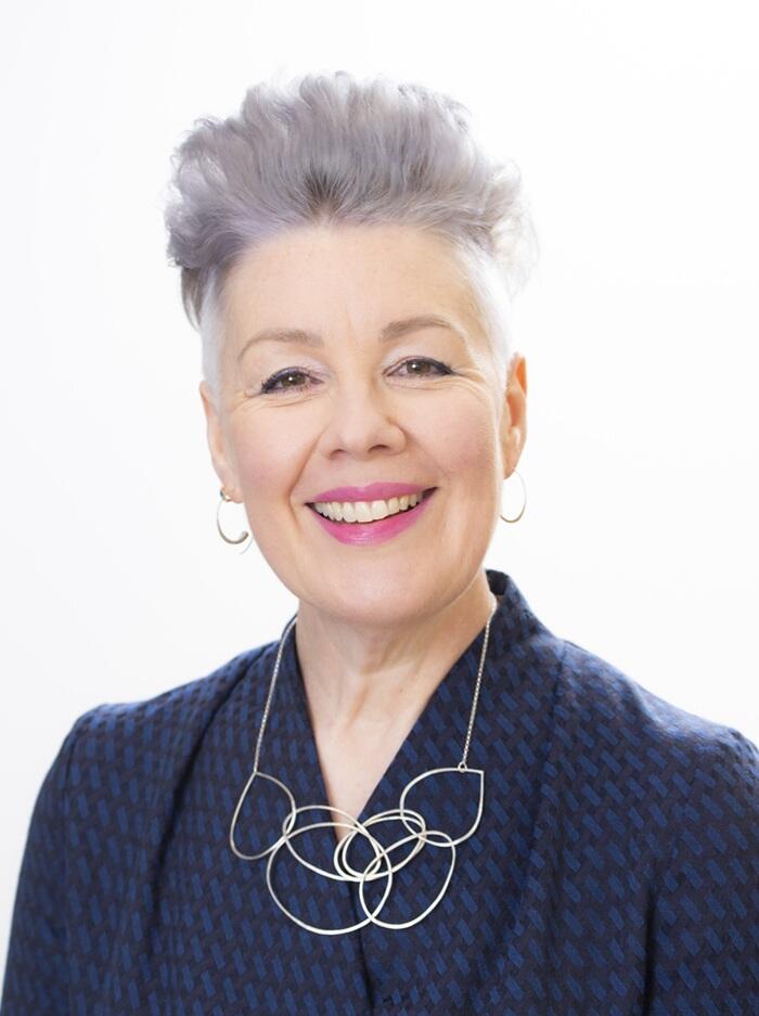 Headshot of Helen Whiteman, CEO of CIOT, smiling in a navy blazer and silver necklace